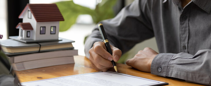 Businessman signing a legal real estate contract agreement, home Insurance.