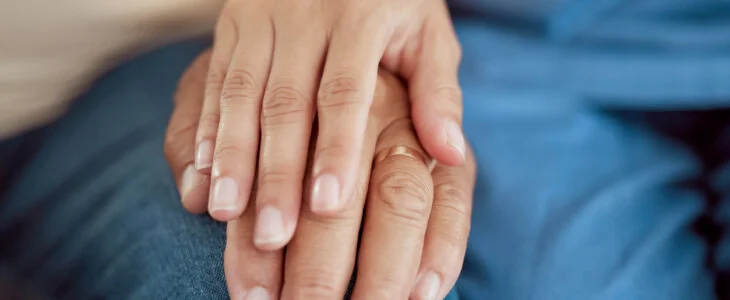 Support, empathy and trust with holding hands of old woman and nurse in retirement home for hope, community and help. Therapy, respect and healthcare with hand of medical caregiver and senior patient